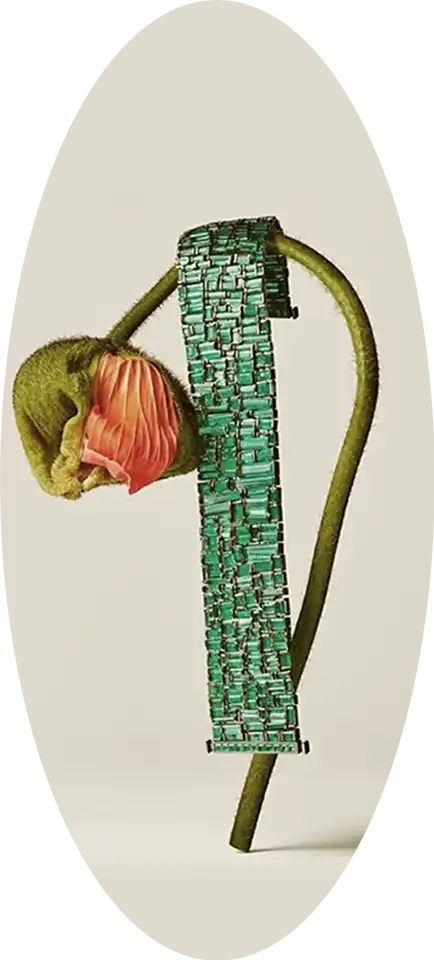A green brecelet hanging from a flower